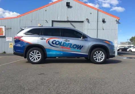 Coldflow SUV in front of warehouse