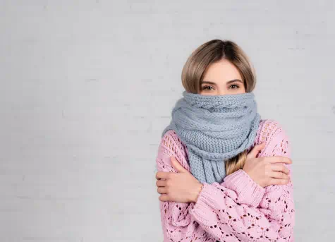 Woman wrapped in clothes and scarf, cold
